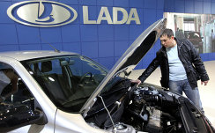 Посетитель осматривает автомобиль Lada Granta