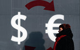 " Знаки доллара и евро на стене пункта обмена валюты в Москве